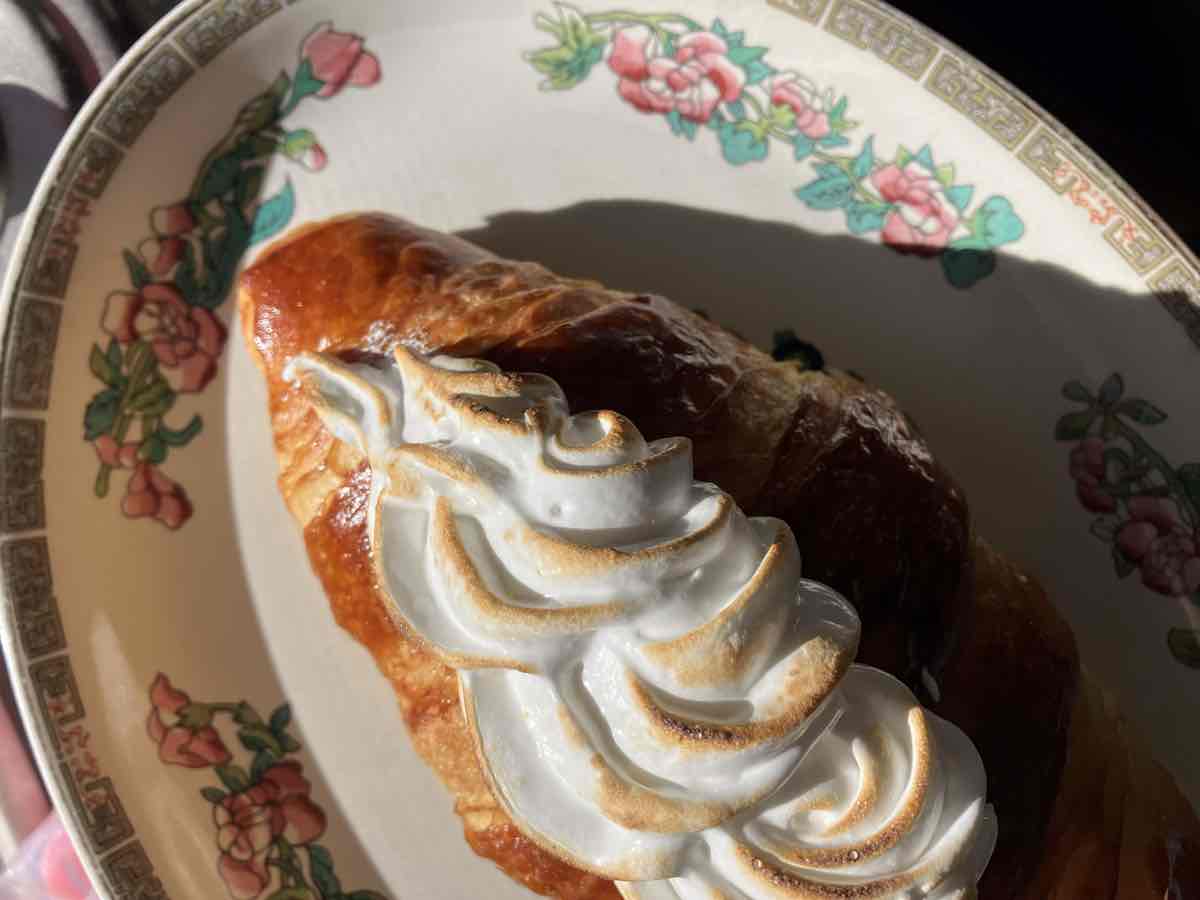 Lemon curd croissant topped with Italian meringue